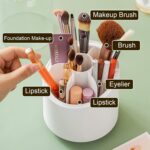 Rotating makeup brush organizer on pink vanity setup with cosmetic brushes in pastel colors