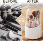 Top down view of rotating brush holder filled with makeup brushes of different sizes