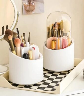 Rotating makeup brush holder with dustproof lid on white vanity table holding 25 makeup brushes