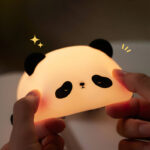 USB rechargeable silicone sleeping panda night lamp on nursery shelf