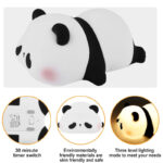 Side angle of sleeping panda night lamp with soft yellow light illuminating